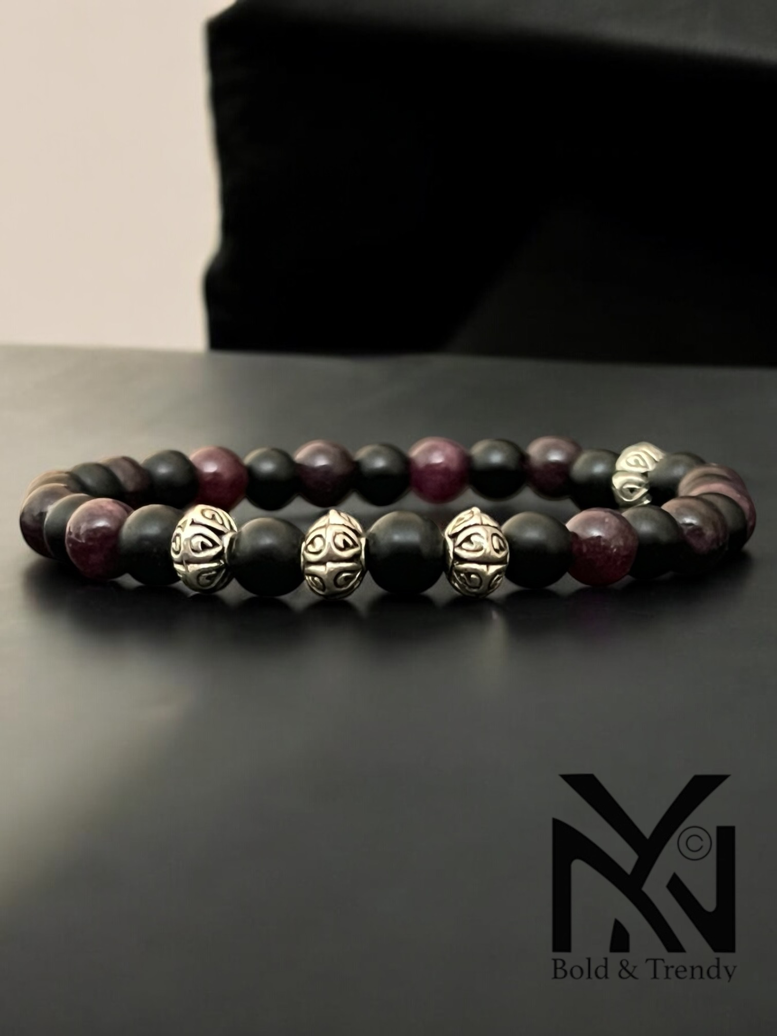 Soleil Rouge bracelet featuring garnet and matte onyx stones, promoting vitality and emotional protection